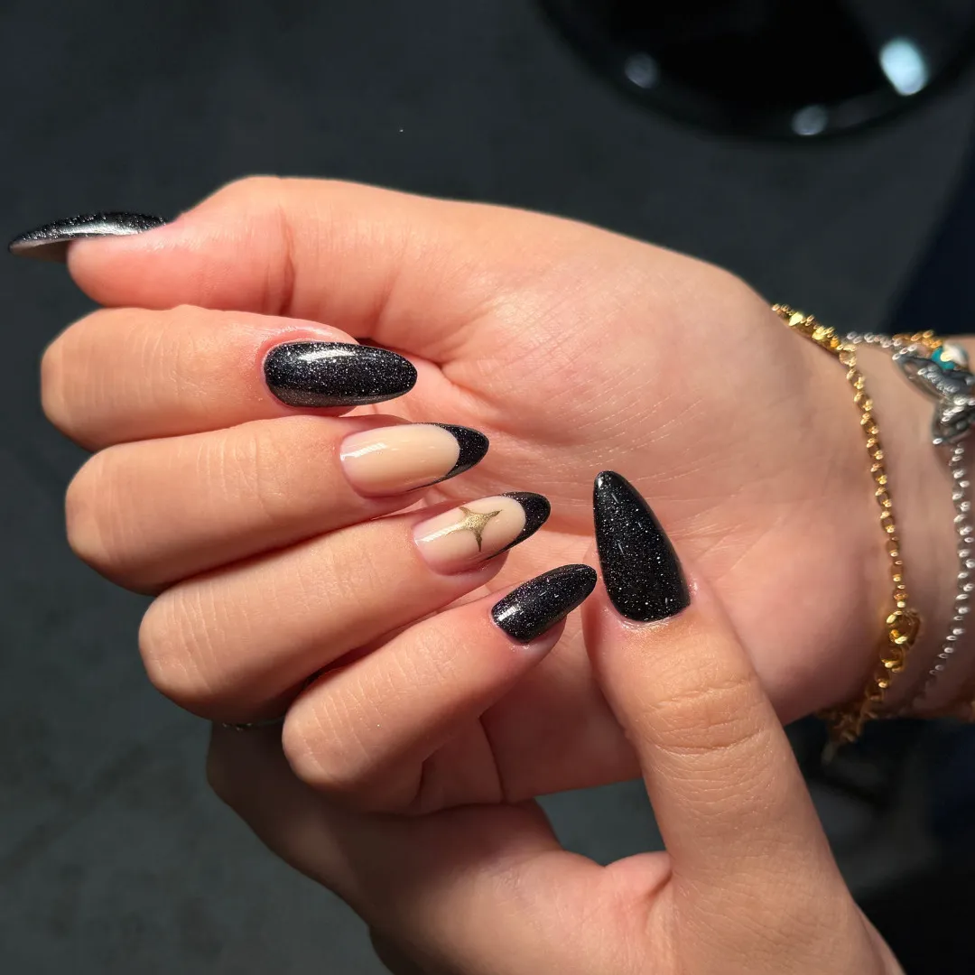 Black glitter nail design with French accent